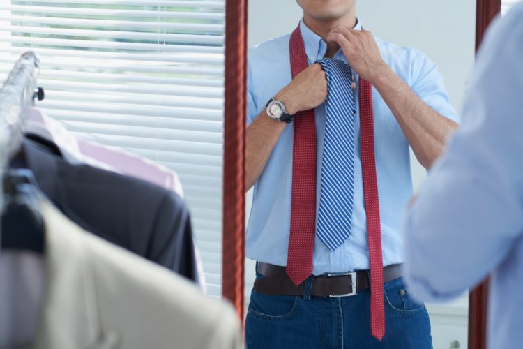Cropped image of man adjusting tie before date